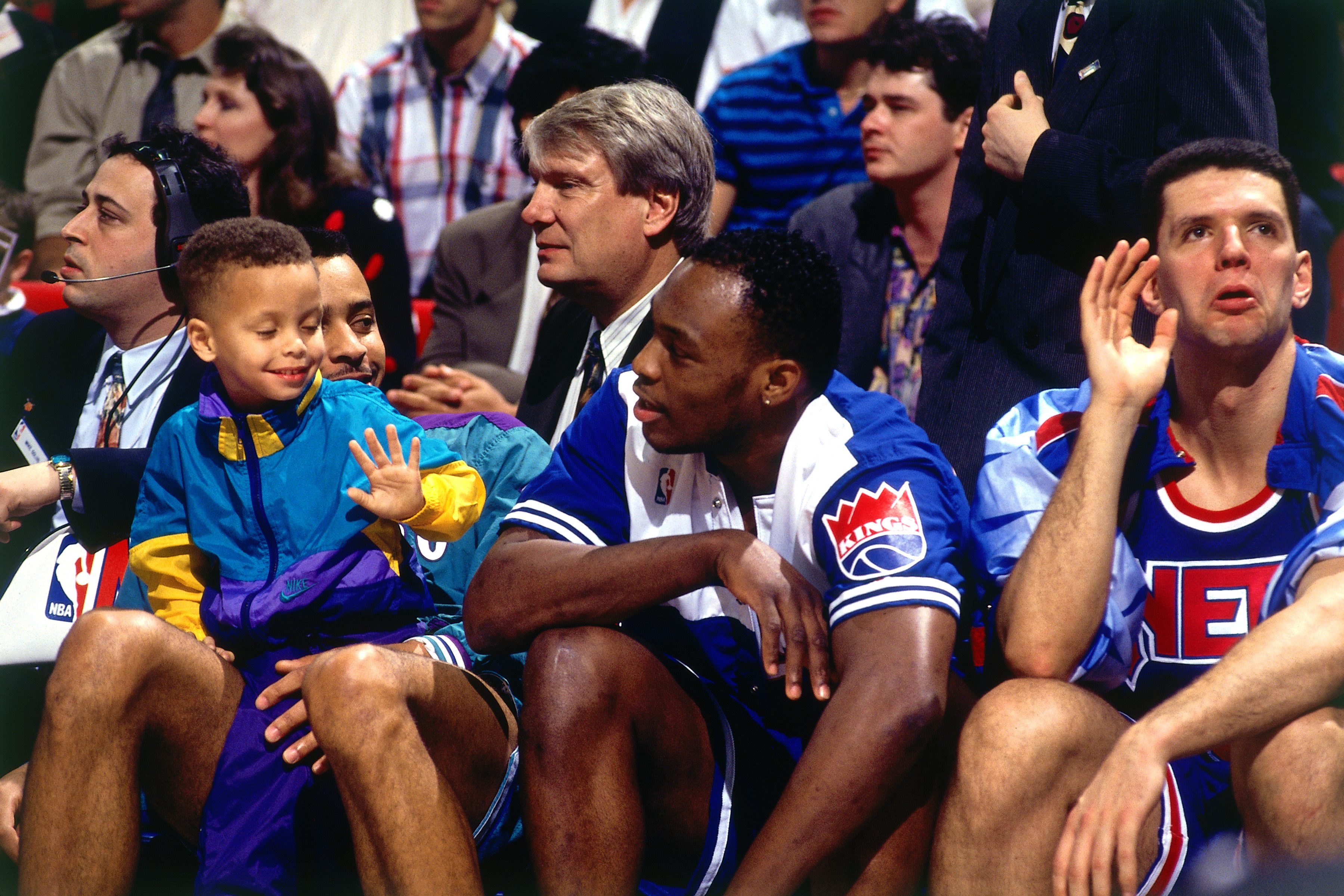 ORLANDO - FEBRUARY 8: (L) Dell Curry #30 of the Charlotte Hornets and his son Stephen Curry sit with Mitch Richmond #2 of the Sacramento Kings and Drazen Petrovic #3 of the New Jersey Nets during the 1992 NBA Three Point Competition on February 8, 1992 at the Orlando Arena in Orlando, Florida. NOTE TO USER: User expressly acknowledges that, by downloading and or using this photograph, User is consenting to the terms and conditions of the Getty Images License agreement. Mandatory Copyright Notice: Copyright 1992 NBAE (Photo by Andrew D. Bernstein/NBAE via Getty Images)